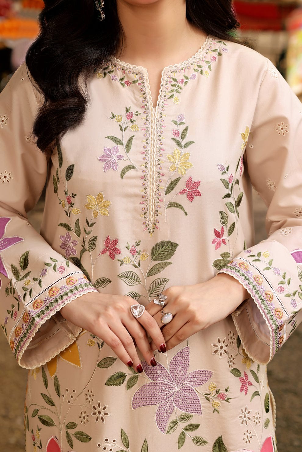 (embroidery close-up): "Detailed floral embroidery on lawn suit fabric"