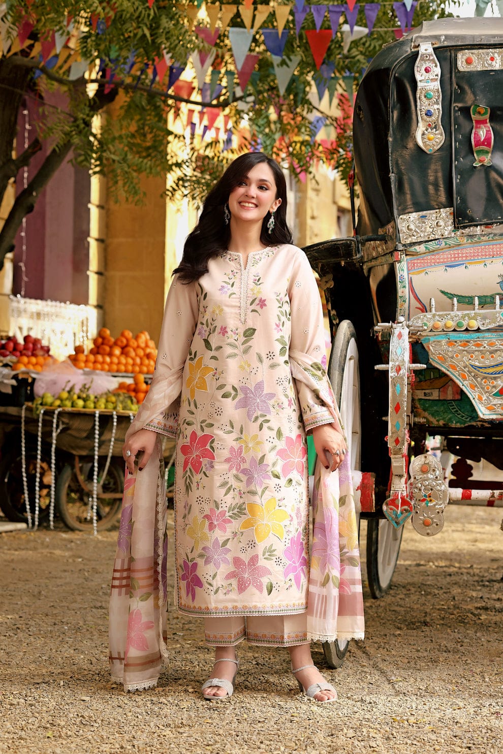 (embroidery close-up): "Detailed floral embroidery on lawn suit fabric"